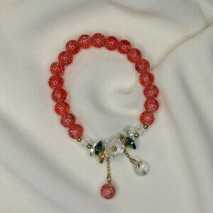 Hot pink beaded bracelet with a white flower charm!